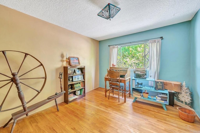 misc room with hardwood / wood-style floors and a textured ceiling