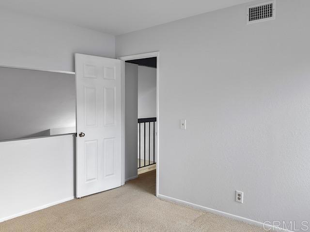 unfurnished bedroom featuring light colored carpet