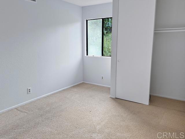 unfurnished bedroom with carpet and a closet