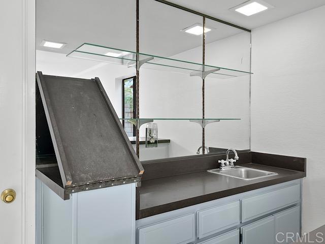 kitchen featuring white cabinets and sink