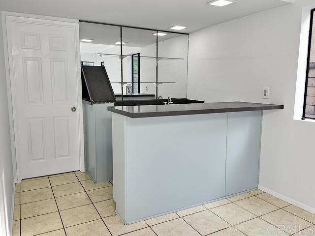 kitchen with kitchen peninsula and light tile patterned flooring