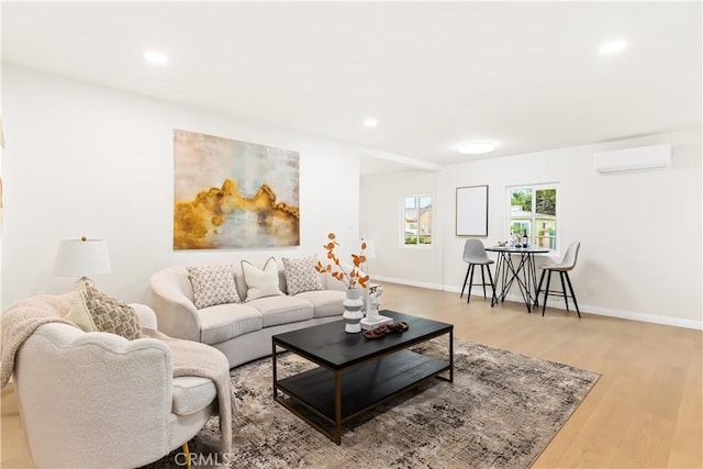 living room featuring light hardwood / wood-style floors and a wall mounted air conditioner