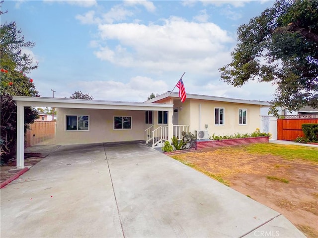 single story home featuring ac unit and a carport