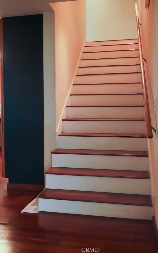 stairs with hardwood / wood-style floors