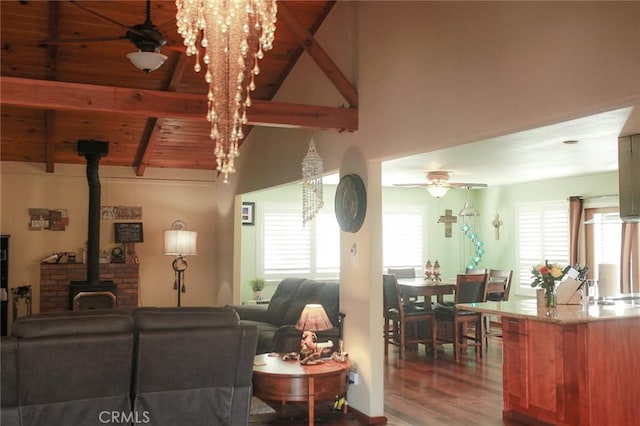 living room with a wood stove, ceiling fan, plenty of natural light, and hardwood / wood-style floors