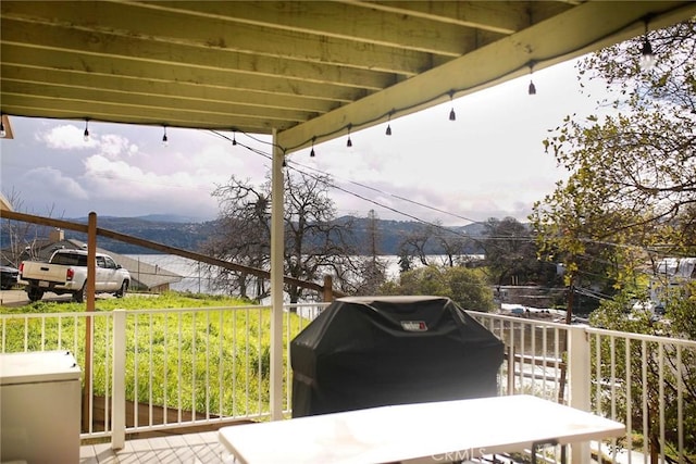 view of patio / terrace featuring a mountain view, a balcony, and grilling area