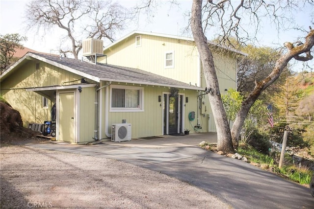 back of property with ac unit and central air condition unit