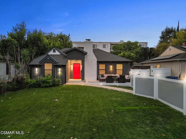 view of front of home featuring outdoor lounge area and a lawn