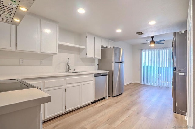 kitchen featuring ceiling fan, sink, light hardwood / wood-style floors, white cabinets, and appliances with stainless steel finishes