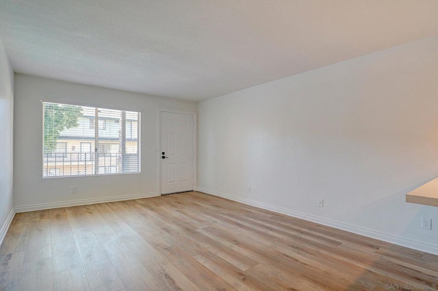 spare room with light hardwood / wood-style floors