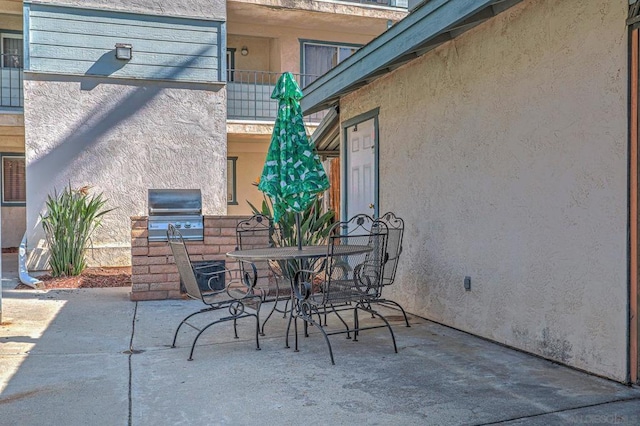 view of patio / terrace featuring area for grilling and a balcony