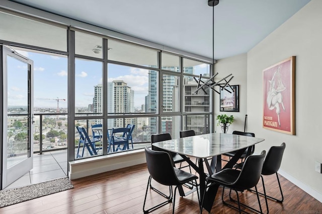 dining area with hardwood / wood-style floors and expansive windows