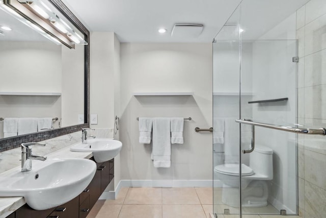 bathroom with tile patterned flooring, vanity, toilet, and a shower with shower door