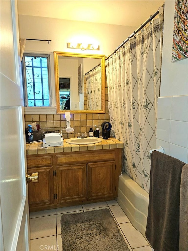 bathroom with backsplash, tile patterned floors, shower / bath combo with shower curtain, and vanity