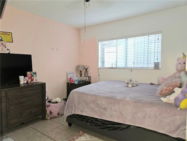 tiled bedroom with ceiling fan