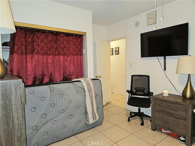 bedroom with light tile patterned floors