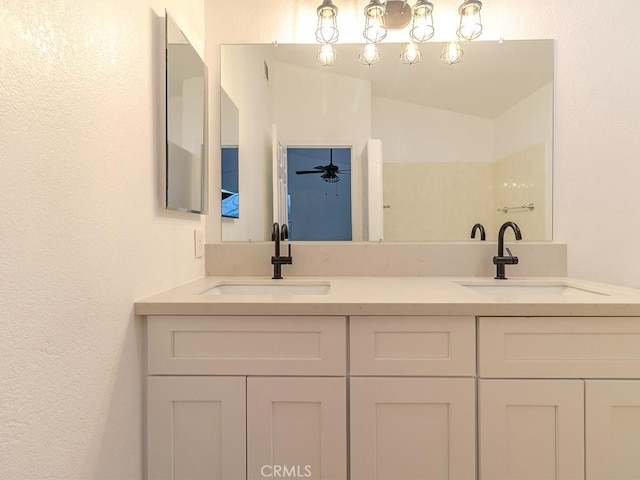 bathroom featuring ceiling fan, vanity, and lofted ceiling