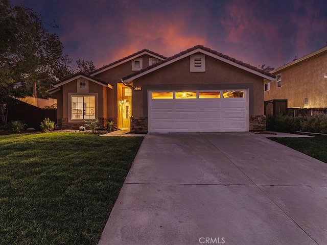 view of front of property with a yard and a garage