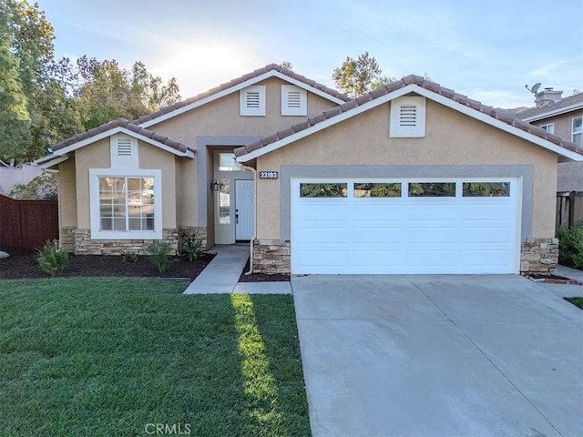 view of front property featuring a garage and a front yard