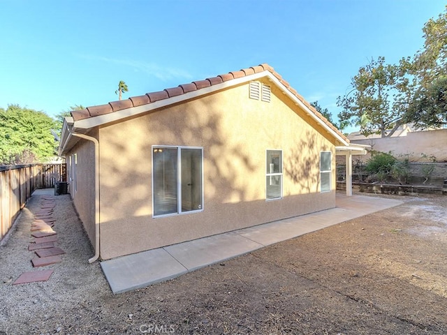 view of side of home with a patio