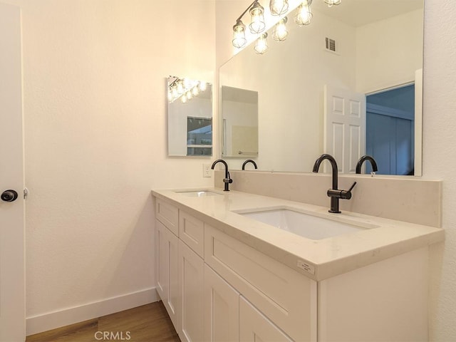 bathroom featuring wood-type flooring and vanity