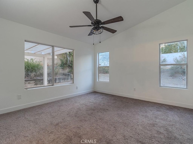 carpeted spare room with ceiling fan and vaulted ceiling