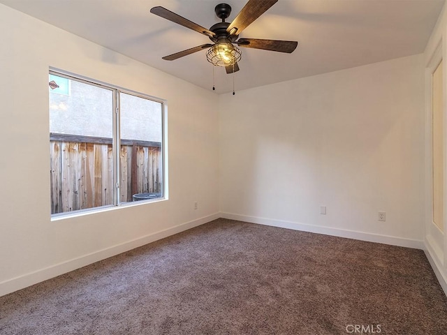 spare room featuring ceiling fan and carpet