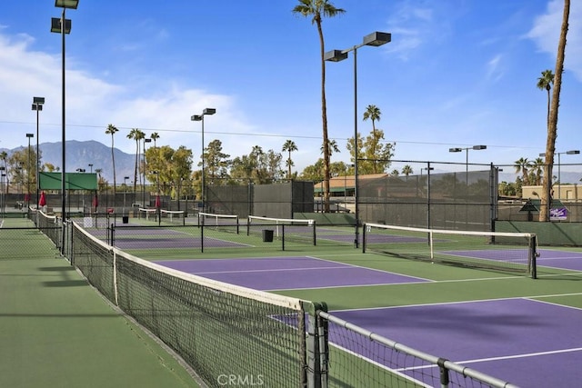 view of sport court with a mountain view and basketball hoop