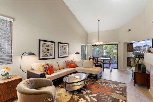 living room featuring a notable chandelier, light tile patterned floors, and high vaulted ceiling