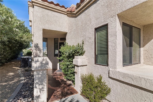 doorway to property featuring central AC unit