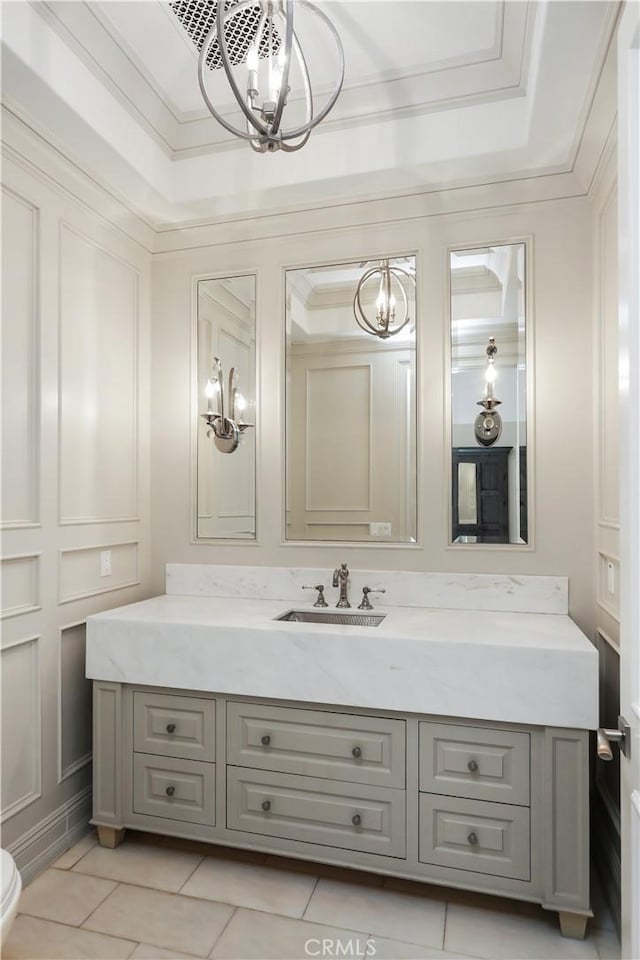 bathroom with ornamental molding, vanity, tile patterned floors, and a notable chandelier