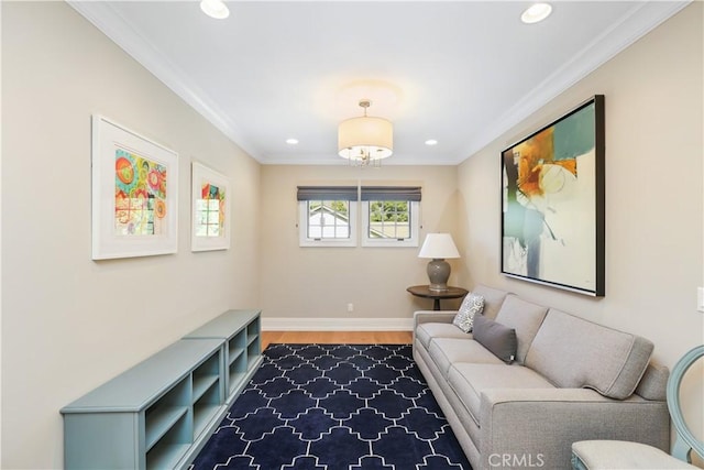 living area featuring hardwood / wood-style floors and crown molding