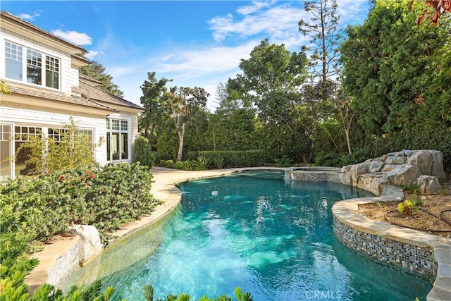 view of pool featuring an in ground hot tub