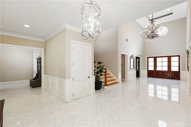 foyer with a high ceiling and crown molding