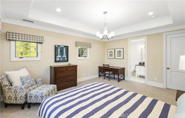 carpeted bedroom featuring ensuite bathroom, an inviting chandelier, ornamental molding, and a tray ceiling