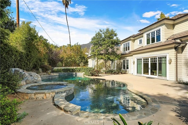 view of pool featuring a patio area and an in ground hot tub