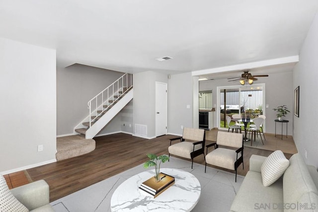 living room with ceiling fan and hardwood / wood-style flooring