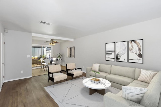 living room featuring wood-type flooring and ceiling fan