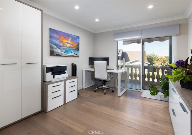 office area with light wood-type flooring and crown molding