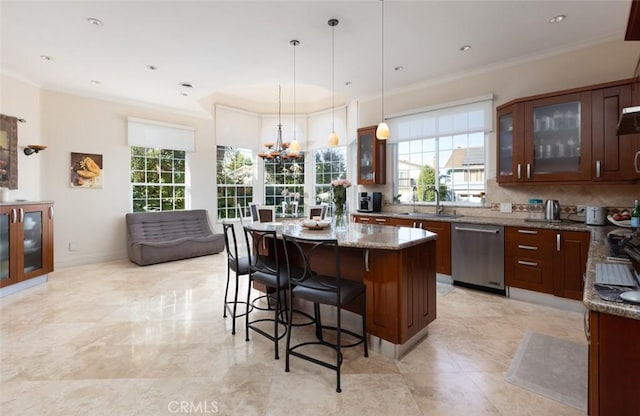 kitchen featuring sink, light stone counters, a center island, stainless steel dishwasher, and hanging light fixtures