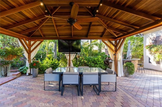 view of patio / terrace featuring a gazebo, ceiling fan, and exterior bar