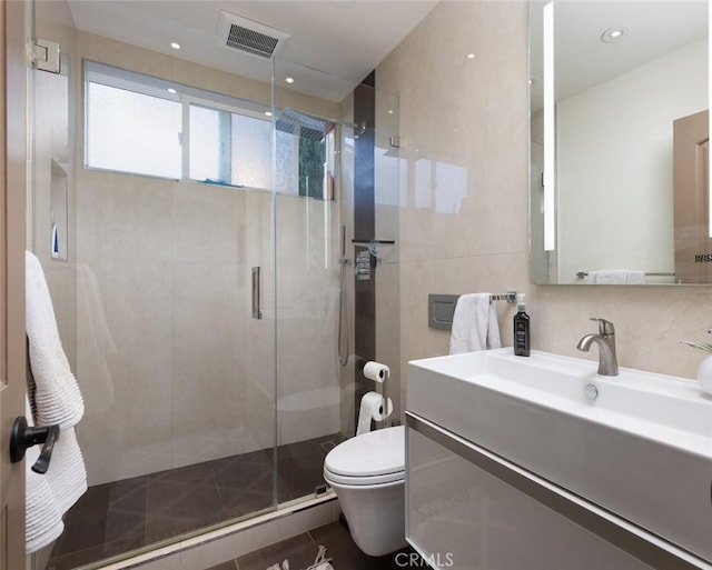 bathroom featuring an enclosed shower, toilet, tile walls, tasteful backsplash, and vanity