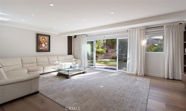 unfurnished living room featuring ornamental molding and hardwood / wood-style floors