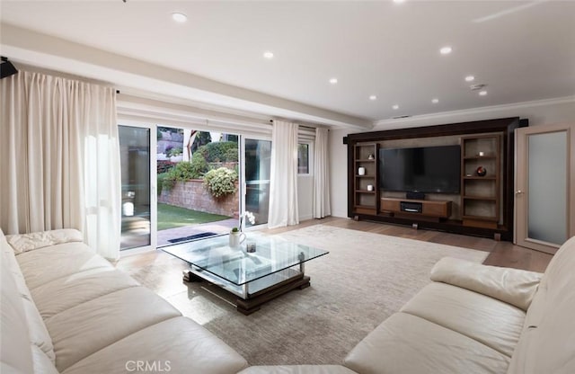 living room featuring light hardwood / wood-style floors and crown molding