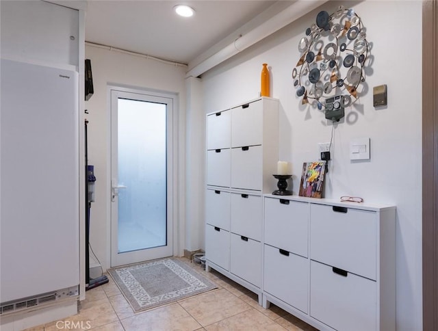 doorway to outside with light tile patterned flooring