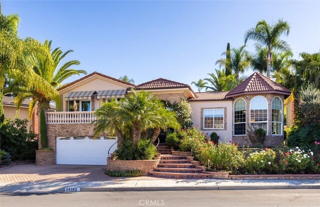 mediterranean / spanish-style home with a garage