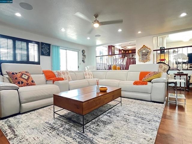 living room with ceiling fan and wood-type flooring