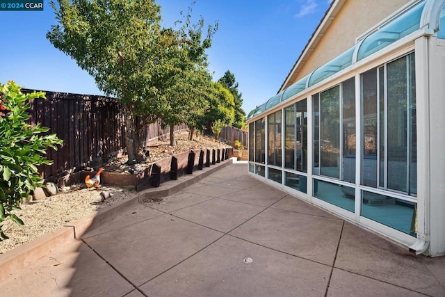 view of patio / terrace with a sunroom