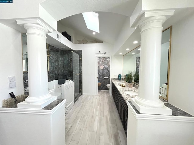 bathroom featuring a shower with shower door, a towering ceiling, vanity, toilet, and hardwood / wood-style flooring