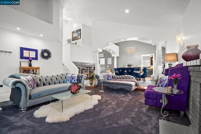 living room with high vaulted ceiling and carpet flooring